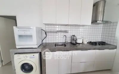 Modern kitchen with sleek cabinetry, gas stove, and built-in appliances for efficient cooking.