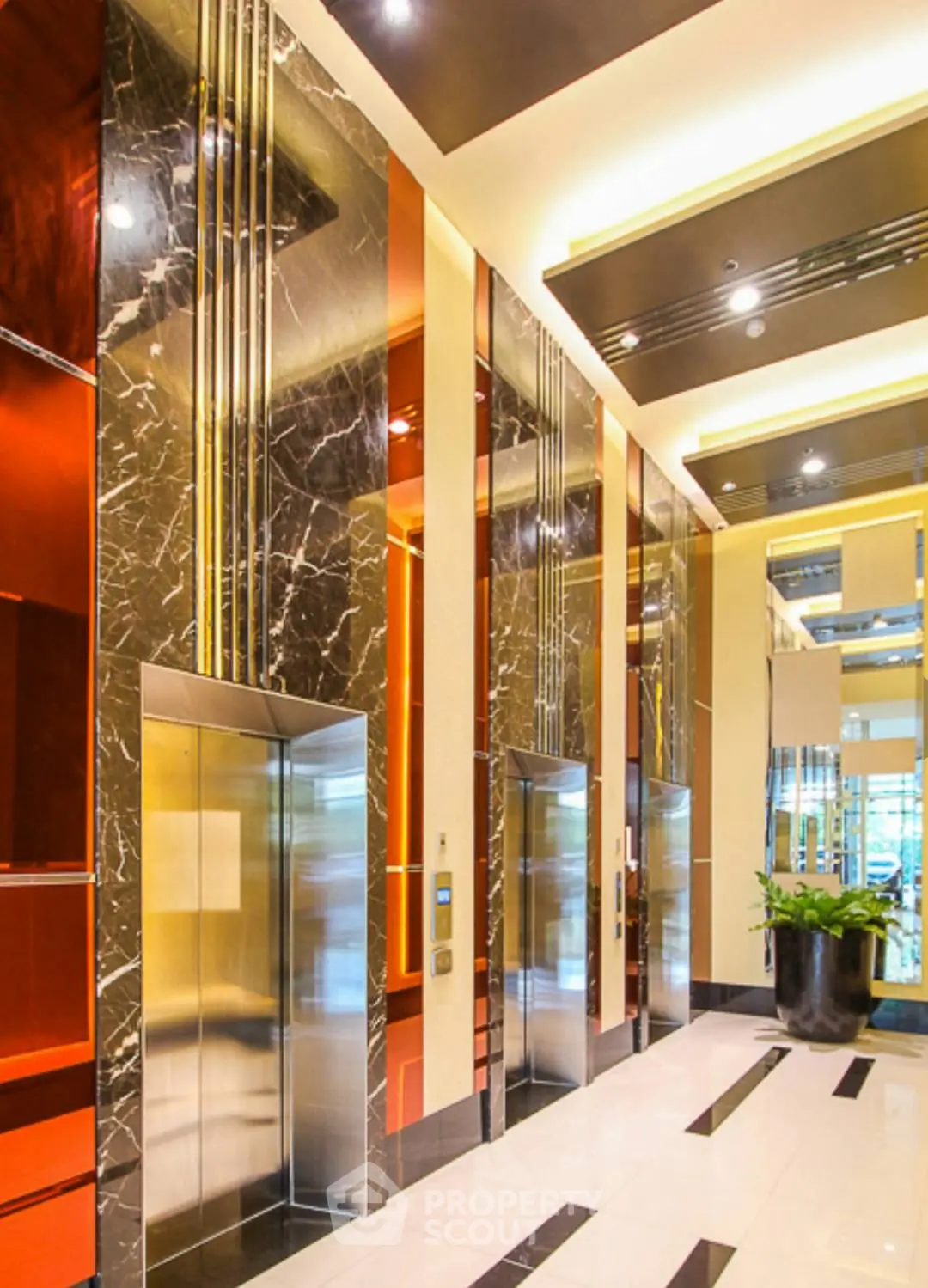 Luxurious modern elevator lobby with marble accents and sleek design.