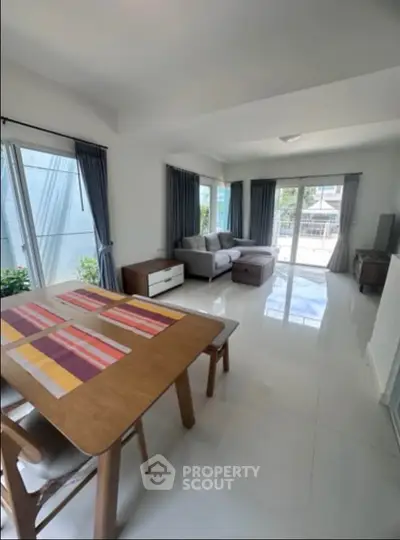 Spacious modern living room with large windows and stylish furniture