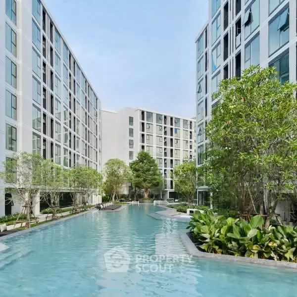 Luxurious apartment complex with stunning pool and lush greenery
