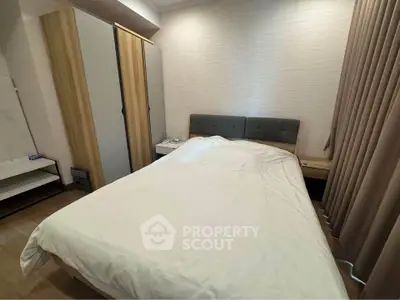 Cozy bedroom with modern furnishings and ample natural light