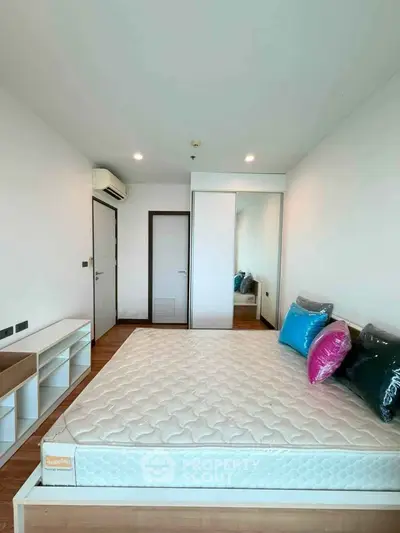 Spacious bedroom with modern decor and ample natural light