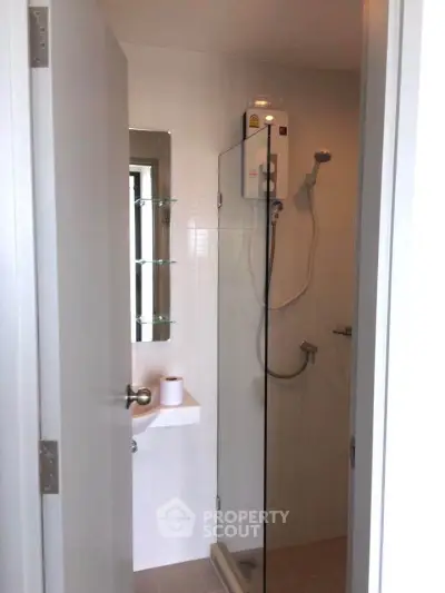 Modern bathroom with glass shower enclosure and sleek fixtures