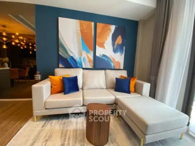 Modern living room with stylish sofa and abstract art, perfect for contemporary home buyers.