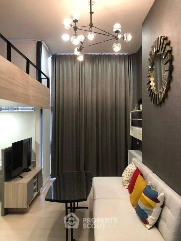 Modern living room with stylish decor and loft design, featuring a cozy sofa and contemporary lighting.