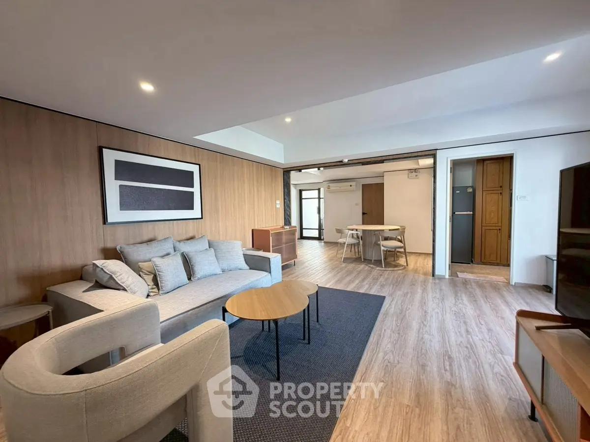 Spacious modern living room with stylish furniture and wooden flooring