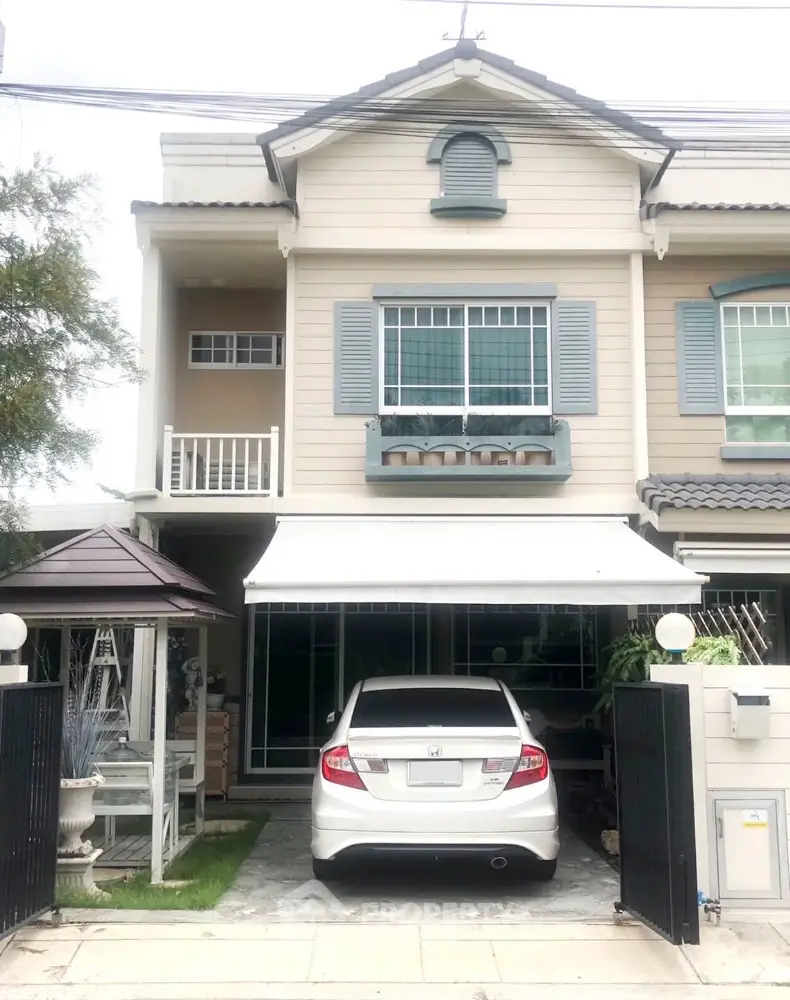 Charming townhouse with carport and stylish facade in a serene neighborhood.