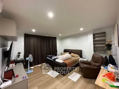 Cozy bedroom with modern furnishings and ample natural light