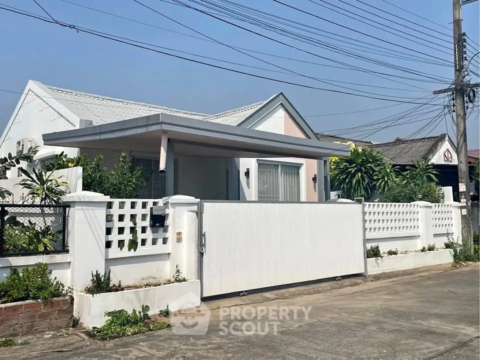 Charming single-story house with modern design and lush greenery in a serene neighborhood.