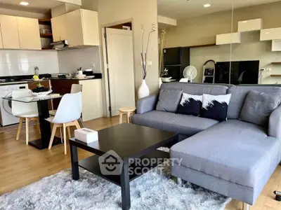 Modern open-layout living room with stylish kitchen and cozy seating area