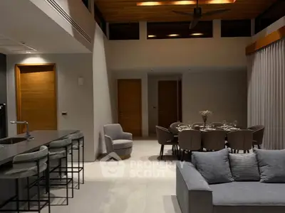 Luxurious modern living room with open kitchen and elegant dining area, perfect for entertaining.