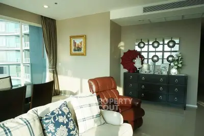 Luxurious living room with elegant decor and ample natural light in modern apartment.