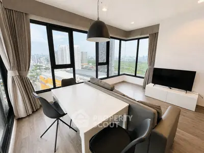 Spacious modern living room with panoramic city views and stylish furnishings.