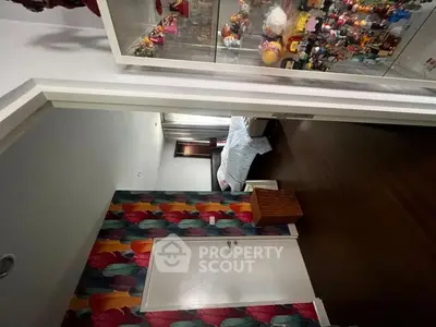 Stylish bedroom with colorful wallpaper and display cabinet in modern home.