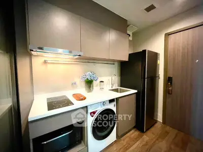 Modern compact kitchen with integrated appliances and stylish cabinetry