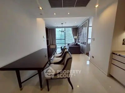 Elegant dining area with modern furniture and large windows offering city views.