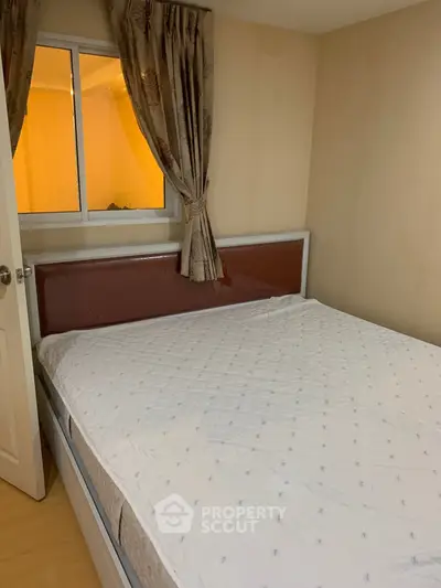 Cozy bedroom with large bed and window, ideal for restful nights.