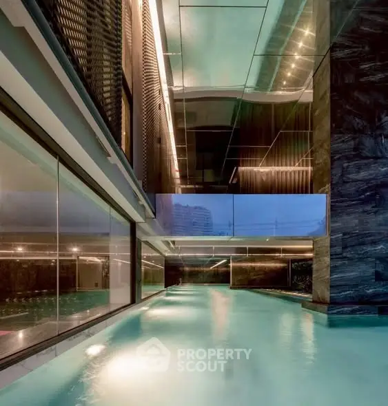 Luxurious indoor pool with modern architectural design and ambient lighting