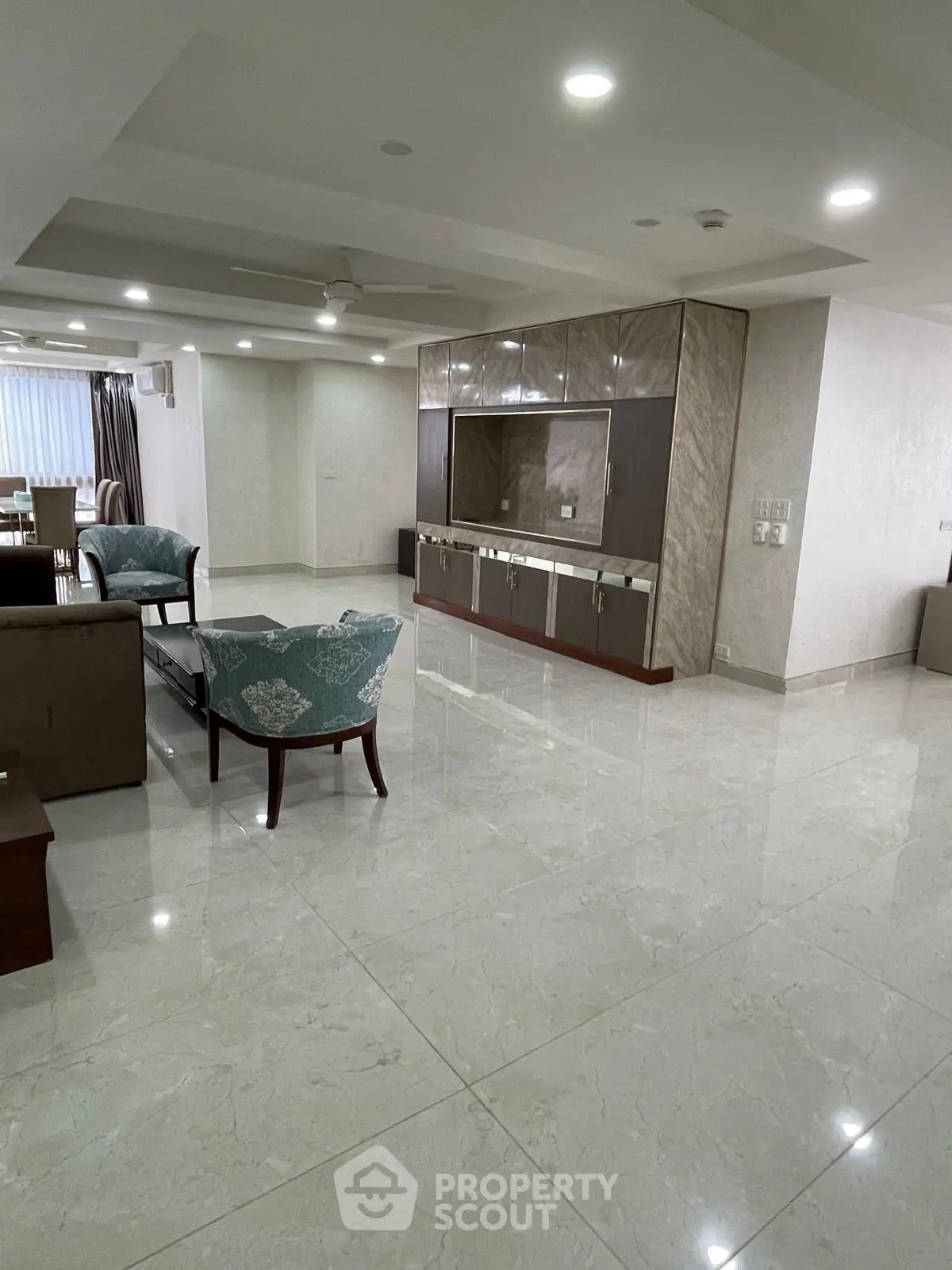 Spacious modern living room with elegant marble flooring and stylish furniture