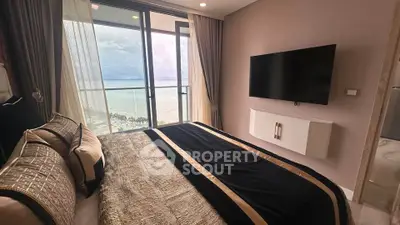 Luxurious bedroom with ocean view and modern decor in high-rise apartment
