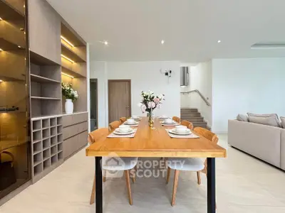 Elegant dining area with wooden table and modern decor in spacious living space