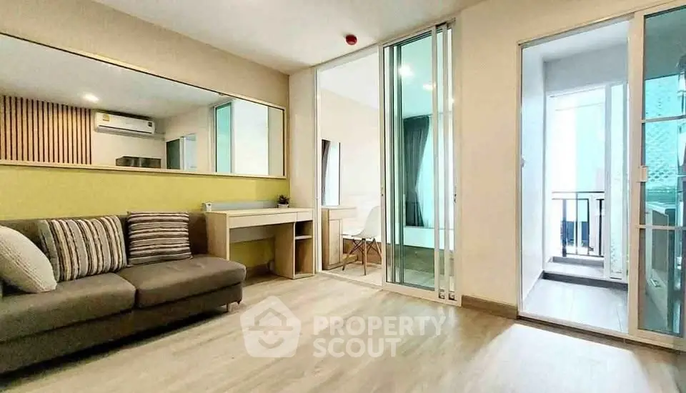 Modern living room with stylish decor and balcony access in a contemporary apartment.