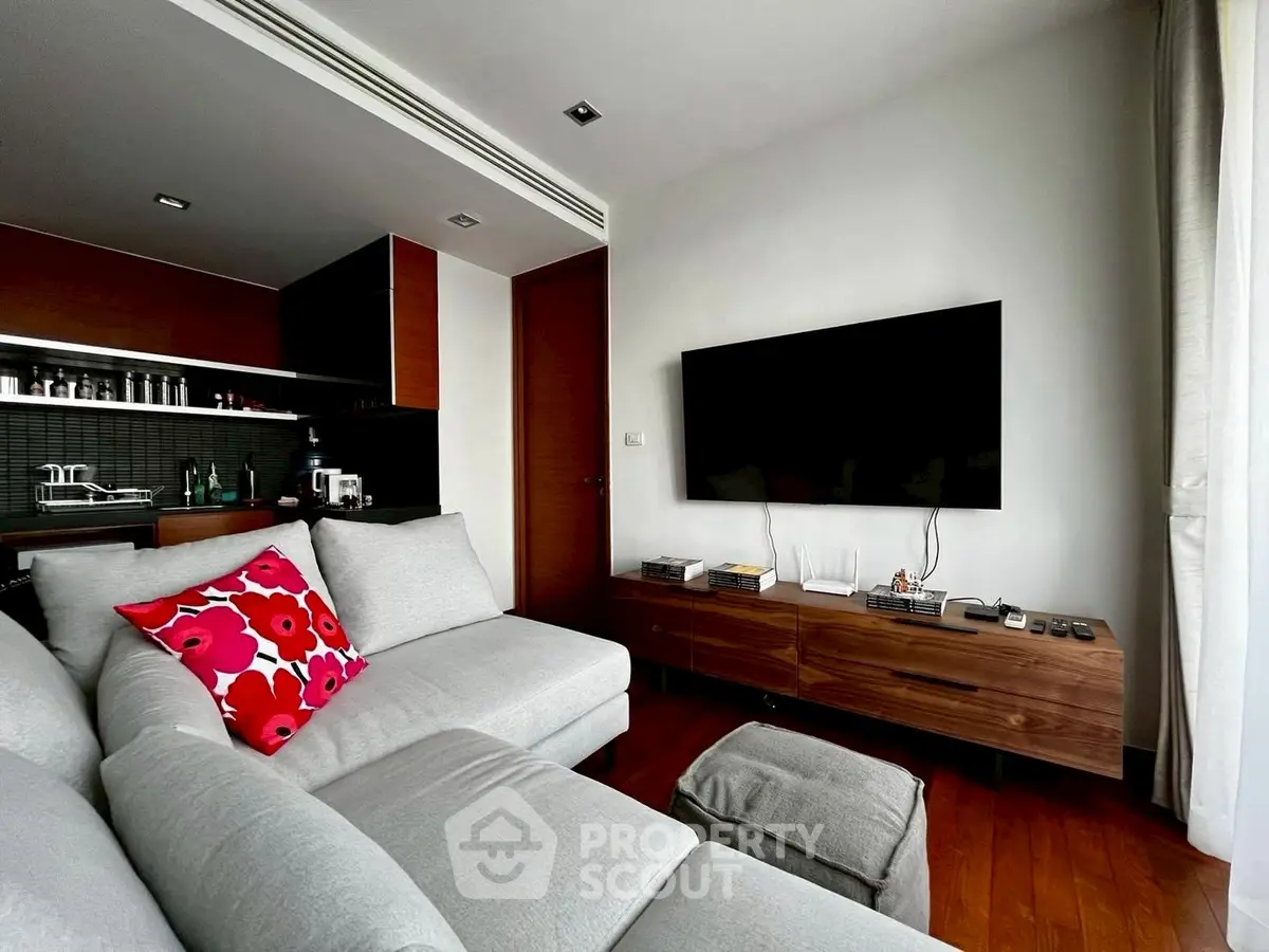 Modern living room with sleek furniture and wall-mounted TV