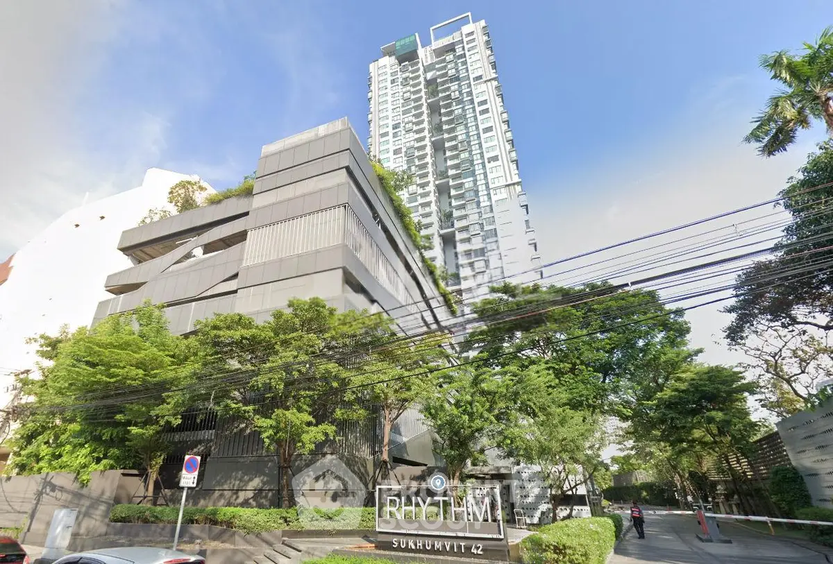Modern high-rise building with lush greenery at Rhythm Sukhumvit 42, offering urban living with scenic views.
