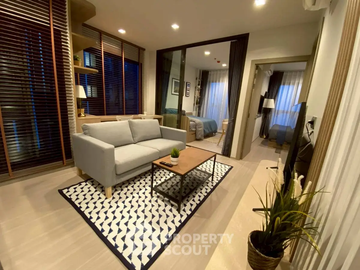 Modern living room with stylish decor and cozy ambiance, featuring a comfortable sofa and elegant lighting.