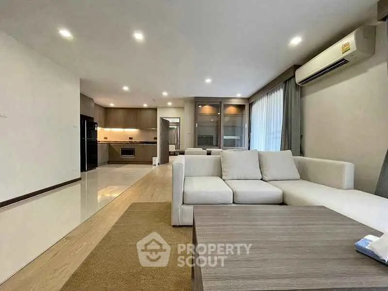 Spacious modern living room with open kitchen and elegant furnishings