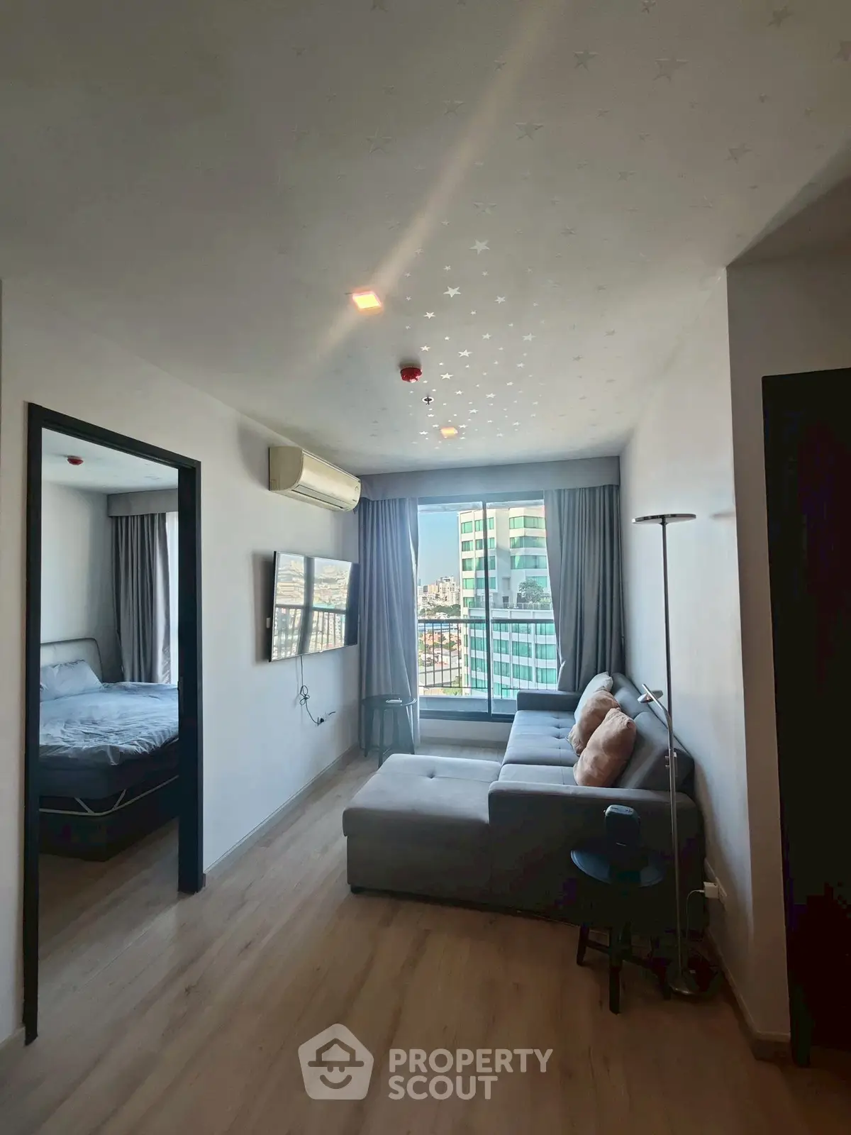 Modern living room with city view and cozy bedroom