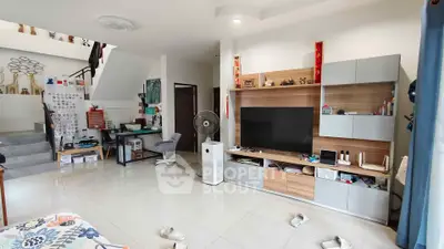 Spacious living room with modern entertainment center and home office setup