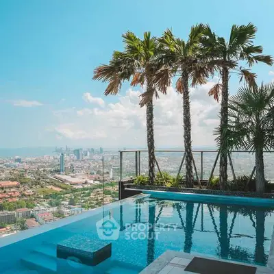 Stunning rooftop pool with panoramic city skyline view and palm trees.