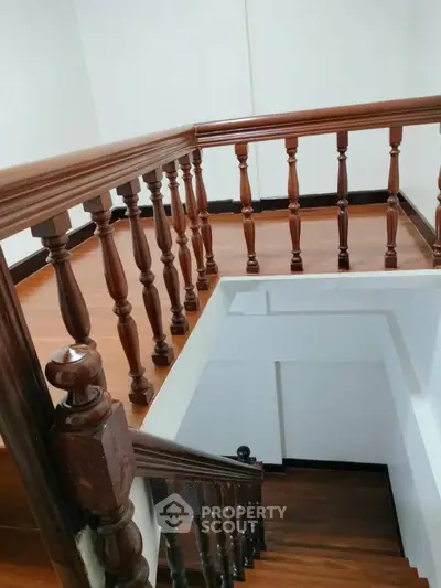 Elegant wooden staircase with polished railing in modern home interior