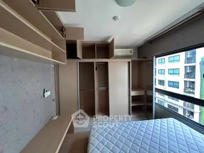 Modern bedroom with built-in wooden storage and large window view