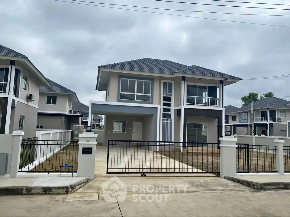 Modern two-story house with spacious driveway and contemporary design in a suburban neighborhood.