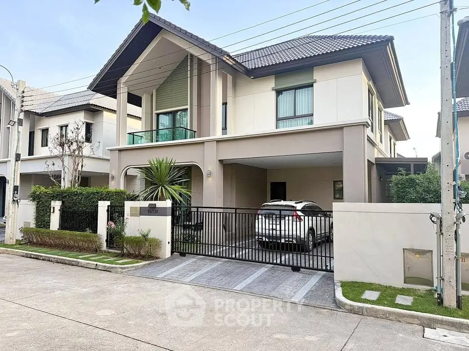 Modern two-story house with driveway and car parked, showcasing contemporary architecture.