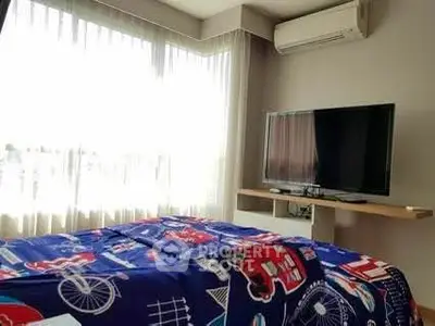 Bright bedroom with large window, air conditioning, and modern TV setup.