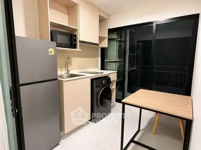 Modern kitchen with sleek appliances and balcony view in a stylish apartment.