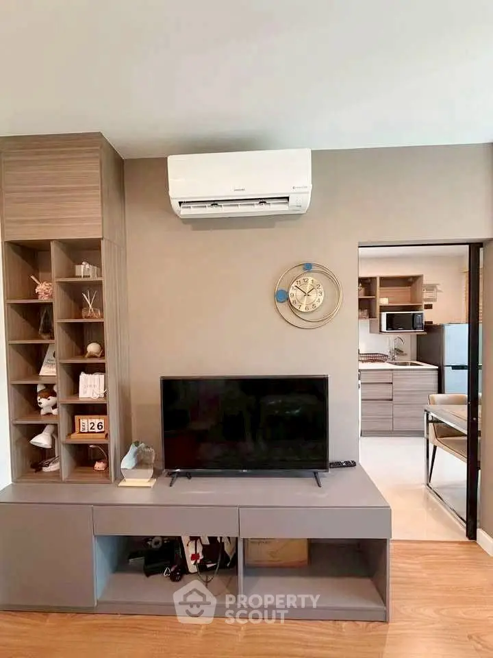 Modern living room with sleek TV unit and open kitchen layout