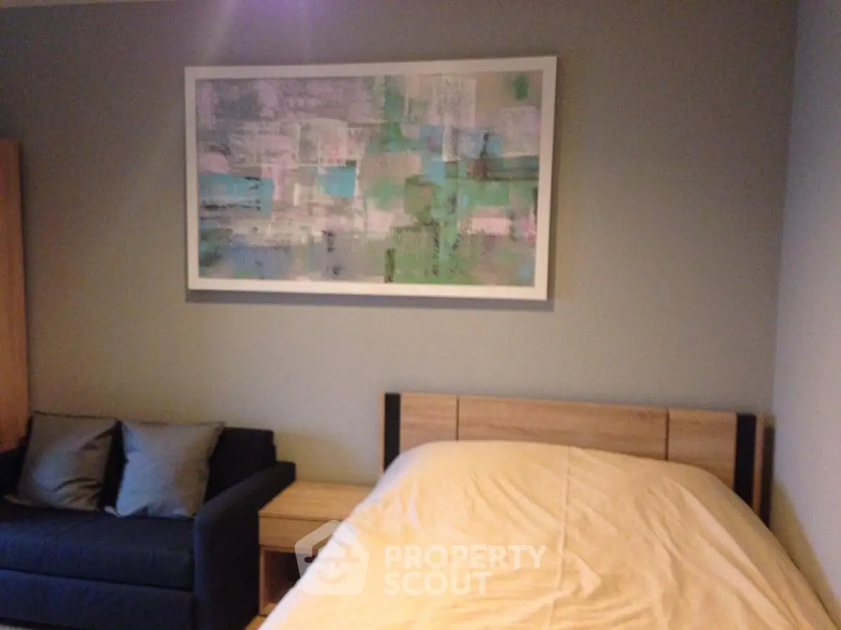 Cozy bedroom with modern art and comfortable bedding