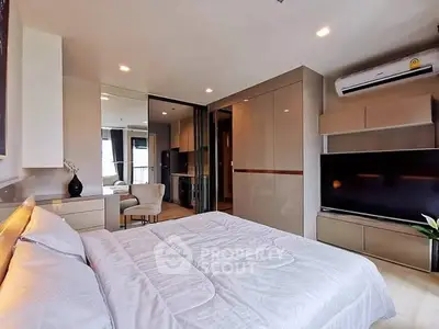 Modern bedroom with sleek design, featuring a large TV and air conditioning.