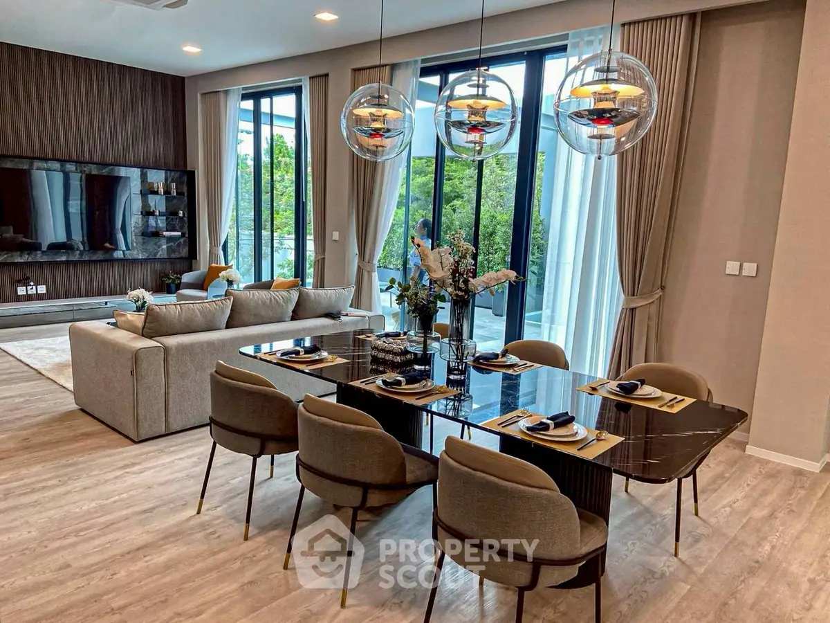 Luxurious open-plan living and dining area with modern decor and large windows.