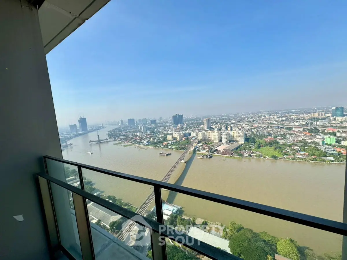 Stunning high-rise balcony view overlooking river and cityscape