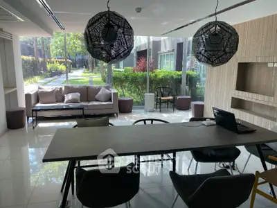 Modern living room with stylish furniture and garden view, perfect for relaxation and entertainment.