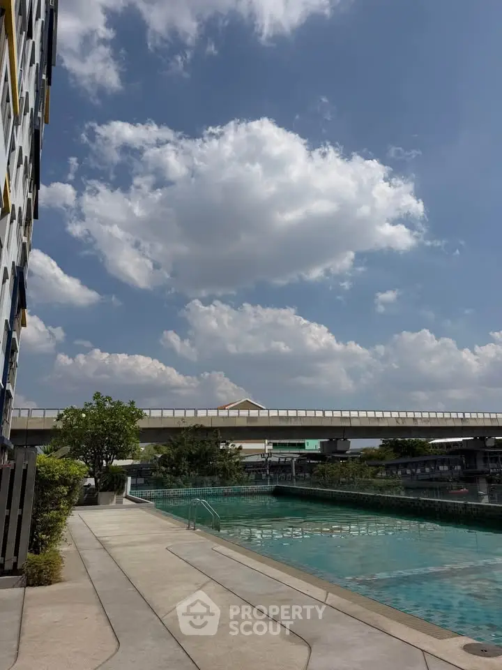 Stunning outdoor pool area with clear blue sky and modern building facade