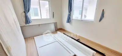 Unfurnished room with large windows and wooden flooring, ideal for customization.
