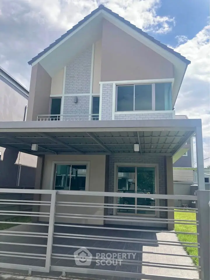 Modern two-story house with large windows and covered carport in a sunny suburban neighborhood.