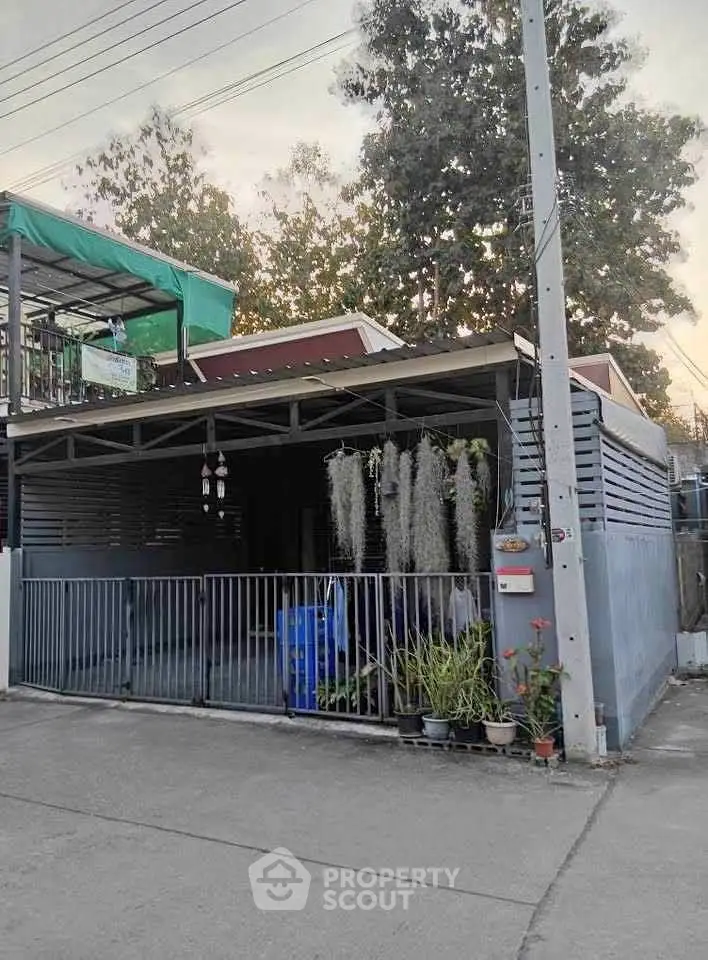 Charming single-story home with gated entrance and lush greenery