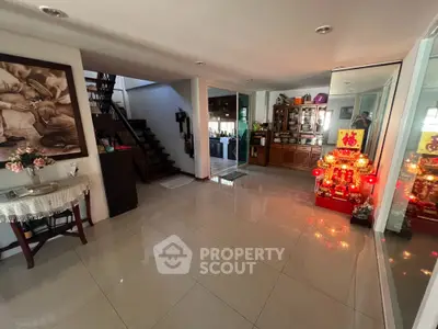 Spacious living area with modern decor and elegant staircase